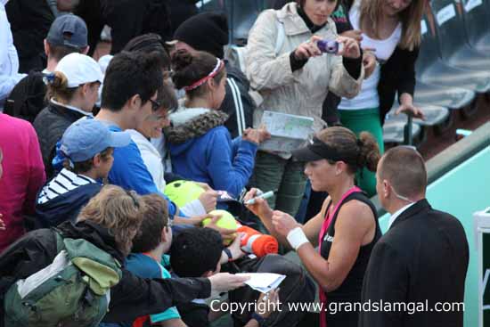 Signing autographs after defeating Sloane Stephens in 2012