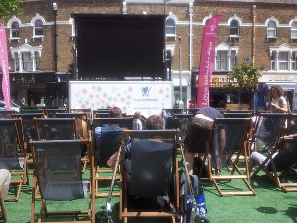 Big screen and deck chairs set up for tennis in the piazza, Wimbledon town centre