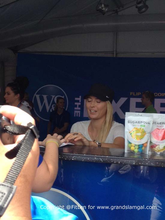 Sharapova signing autographs at the experience booth